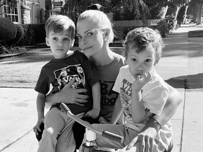 Jaime Pressly is carrying Leo Hijazi on her lap, and Lenon Hijazi is sitting on a cycle.